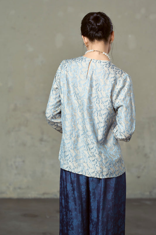 Back of blue paisley silk blouse showing pearl button and keyhole at the neck