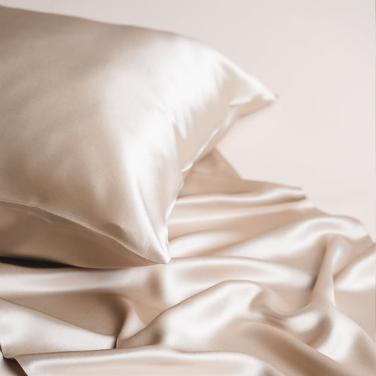 Beige mulberry silk pillowcase styled on a bed