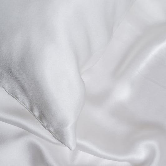 White mulberry silk pillowcase styled on a bed