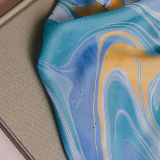 Model wearing marbled blue hand-marbled silk scarf draped over shoulders — Silk & Bears