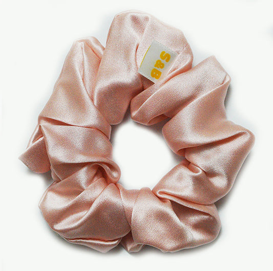 Large mixed-colour silk scrunchies worn in the hair