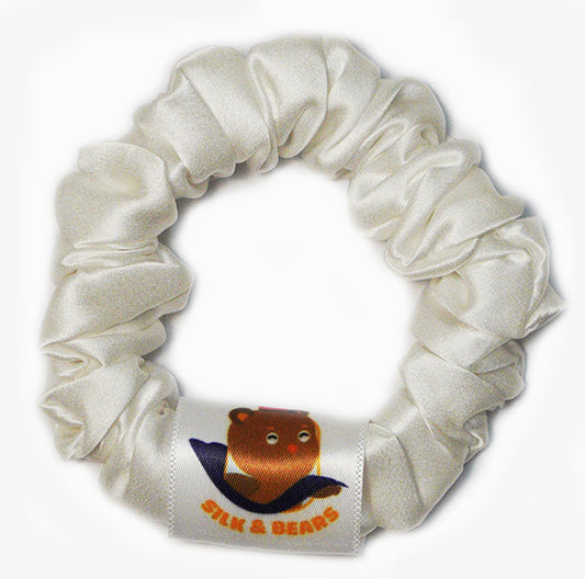Medium white silk scrunchies worn in the hair