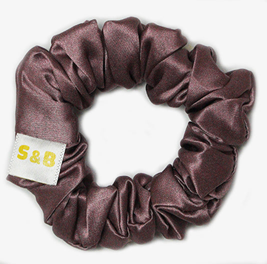 Medium dark peach silk scrunchies worn in the hair