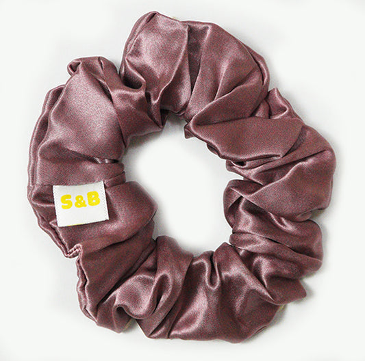 Large mixed-colour silk scrunchies worn in the hair