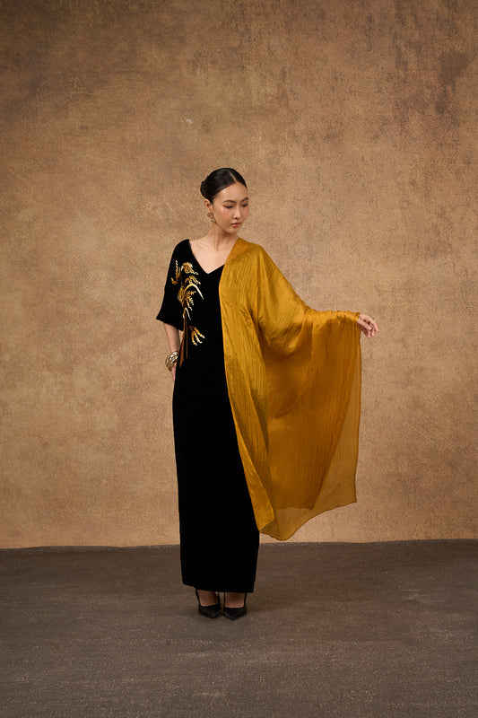 Close-up of the gold hand-dyed silk scarf, showing texture and natural lustre