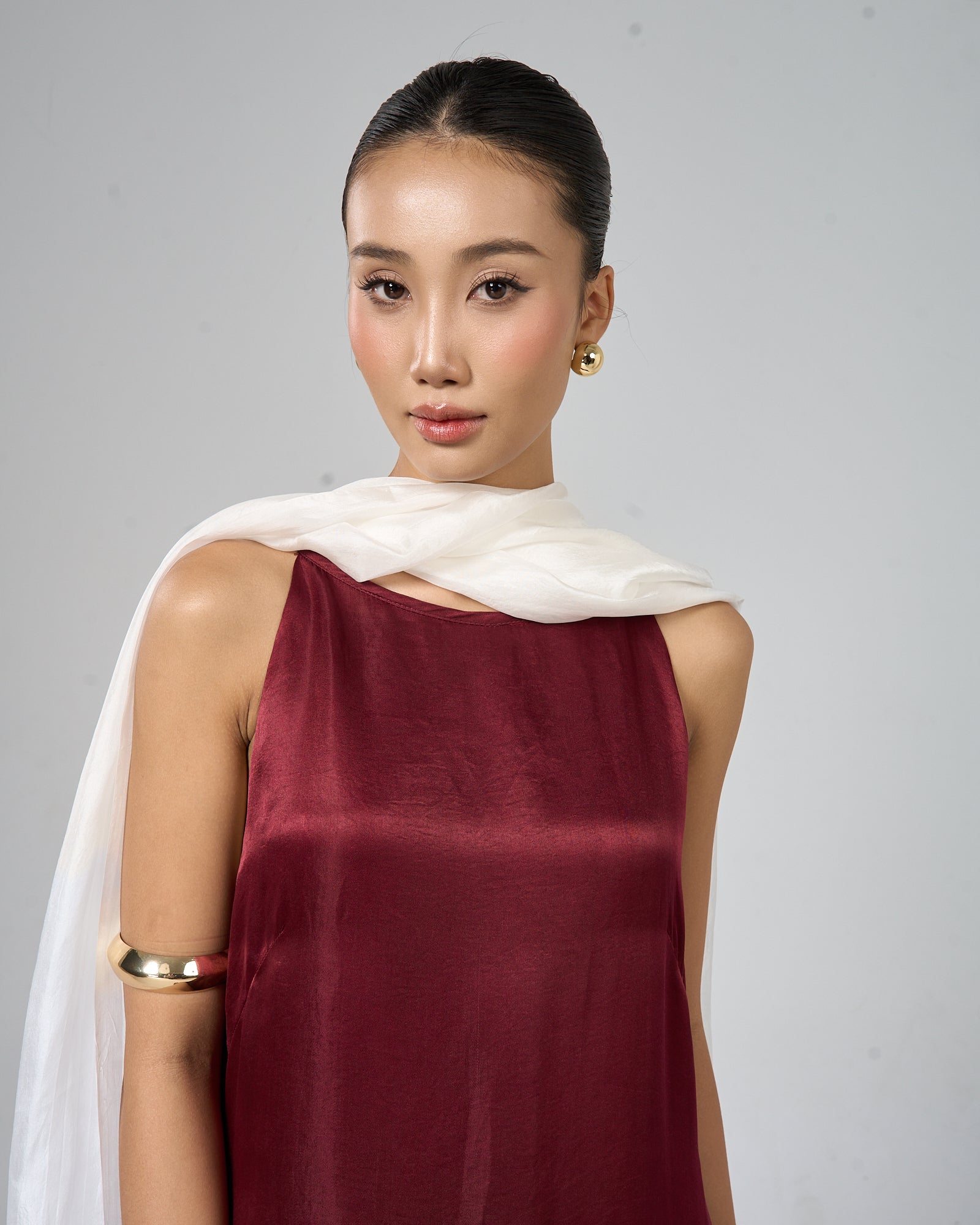 Pearl white hand-dyed mulberry silk scarf draped elegantly, styled for a wedding guest