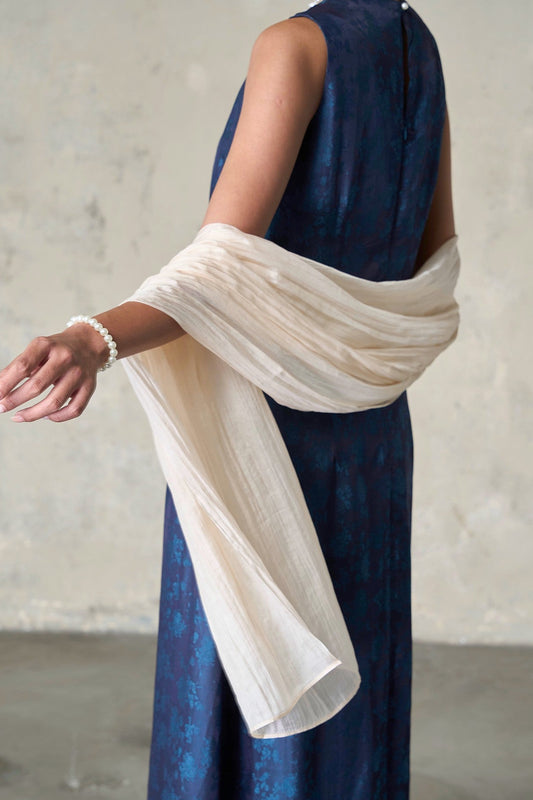 Pale champagne silk scarf wrapped across the shoulders over a navy dress, hand-dyed mulberry habotai