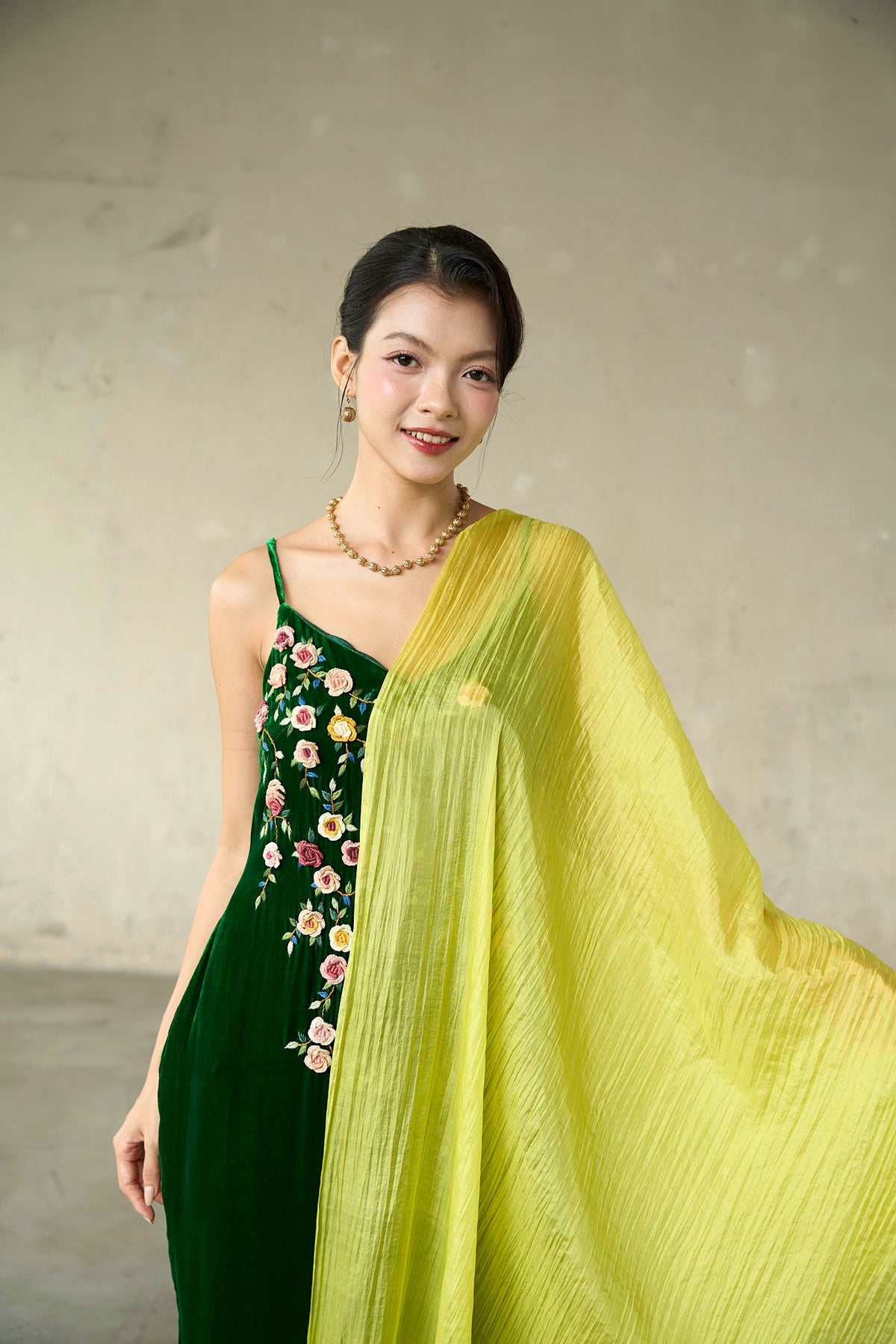 Citrine hand-dyed mulberry silk scarf in chartreuse yellow, draped over the shoulder with an emerald velvet embroidered dress