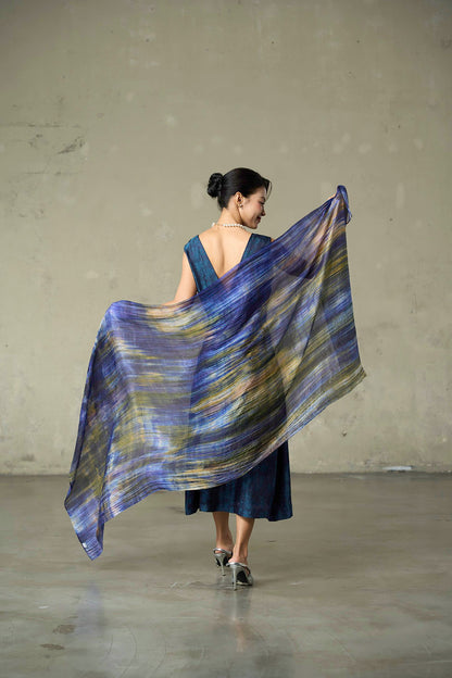 Iris Field hand-dyed silk scarf held open in movement, showing indigo, olive gold and lilac bands