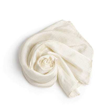 Oyster silk scarf coiled on a white background, showing the hand-rolled hem and slubbed weave