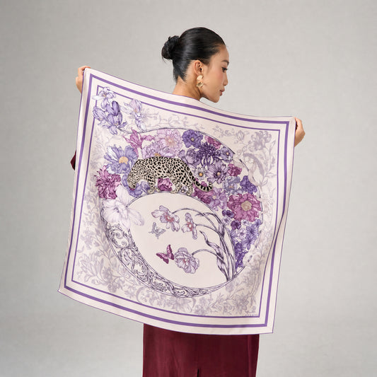 Leopard and floral 90x90cm printed silk scarf held open to show the full lilac design