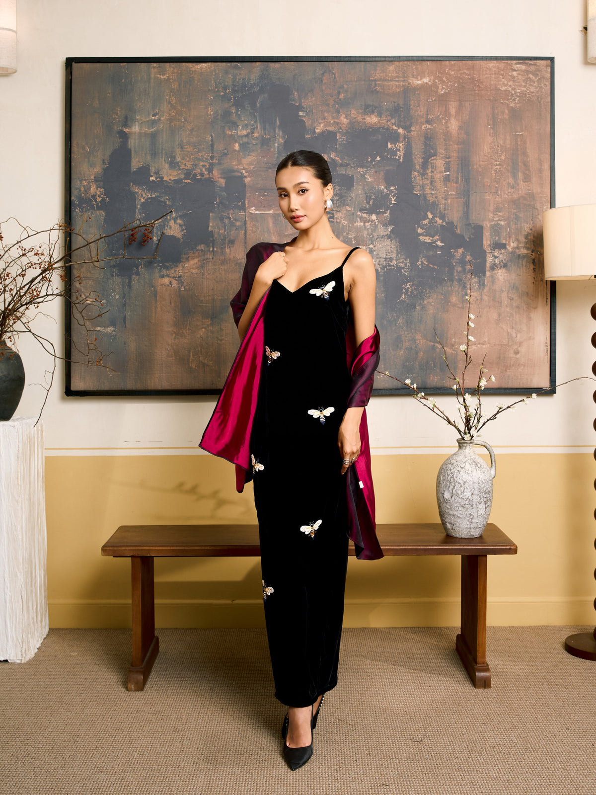 Model wearing the plum and fuchsia reversible silk shawl with the bright fuchsia side folded back as lapels