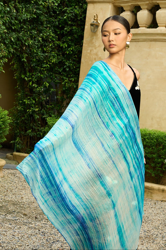 Close-up of the sky blue brushstroke silk scarf draped over the shoulder