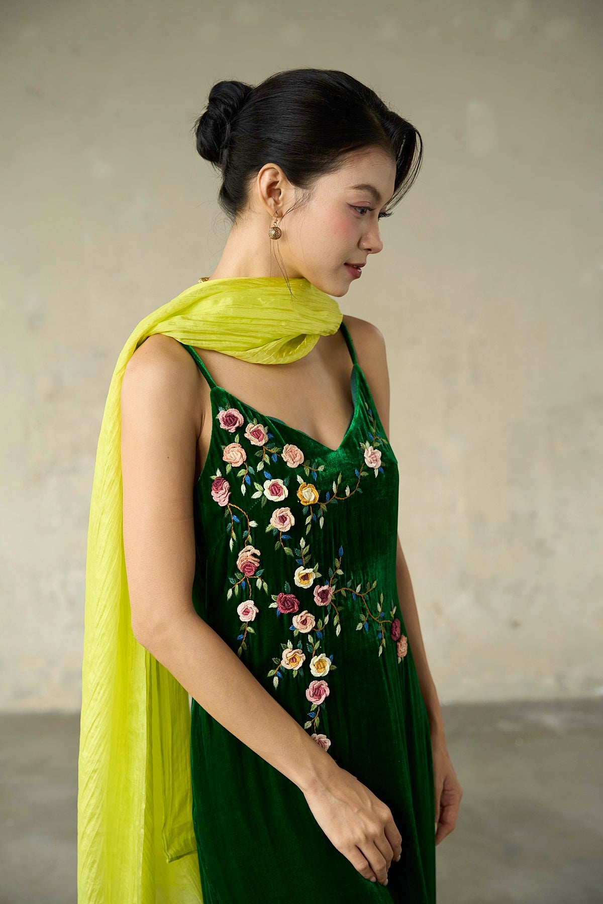 Chartreuse citrine silk scarf wrapped at the neck over green velvet, full length falling to the hip