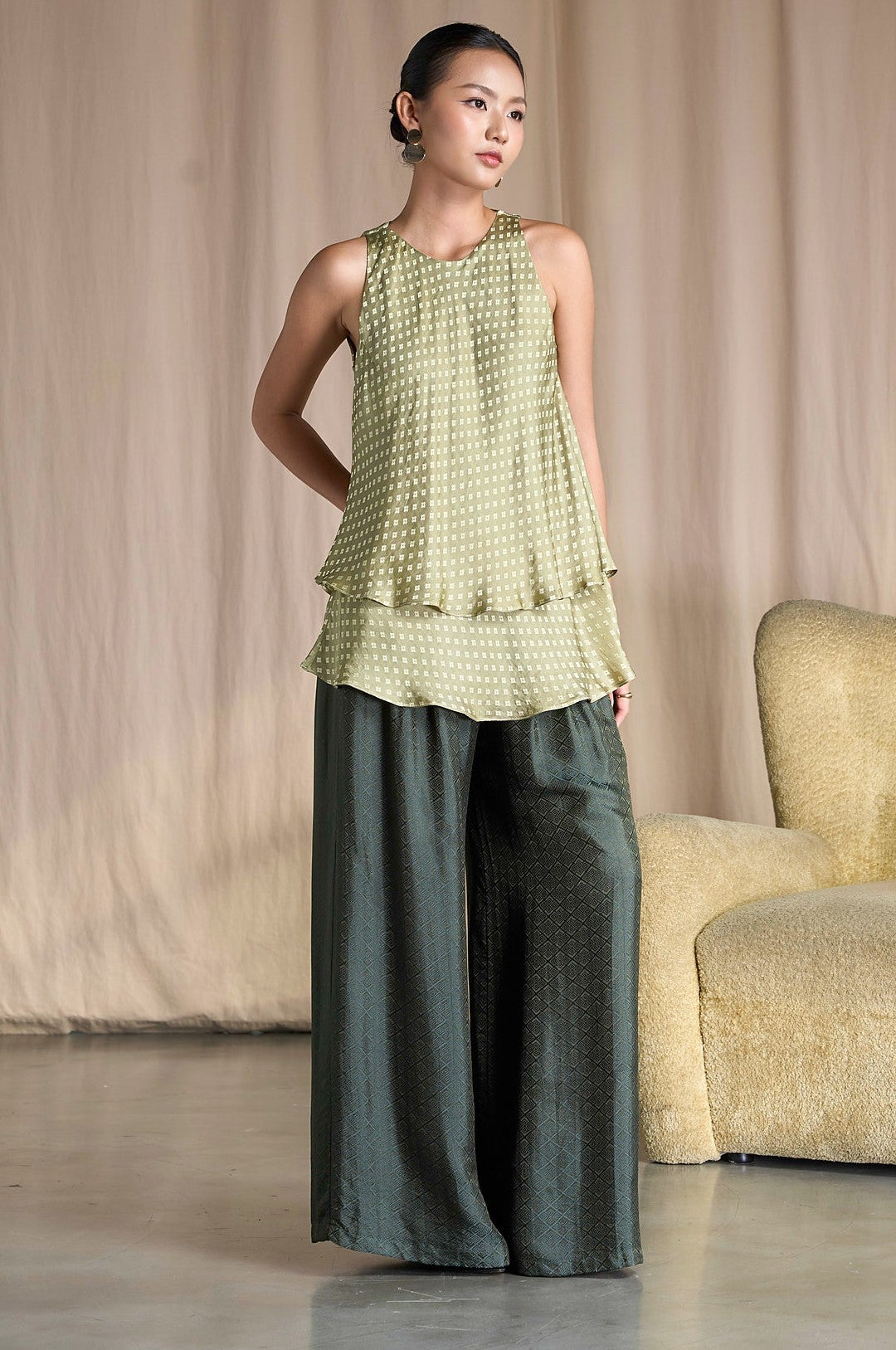 Model wearing Portia Khaki Diamond silk jacquard wide-leg trousers with a sage tiered silk top, full length front