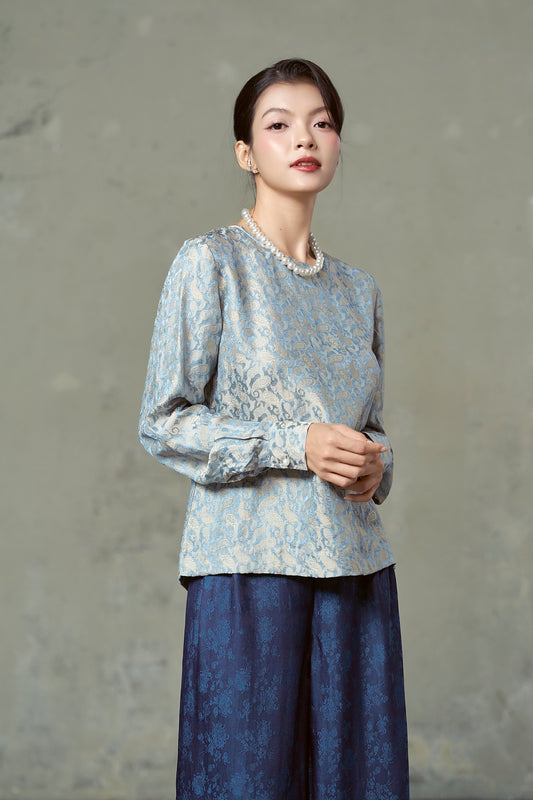 Model in blue and gold paisley silk jacquard blouse with full sleeves, Rosalind Delft Gold
