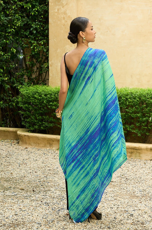 Back view of the green and blue brushstroke silk scarf draped over one shoulder, full length