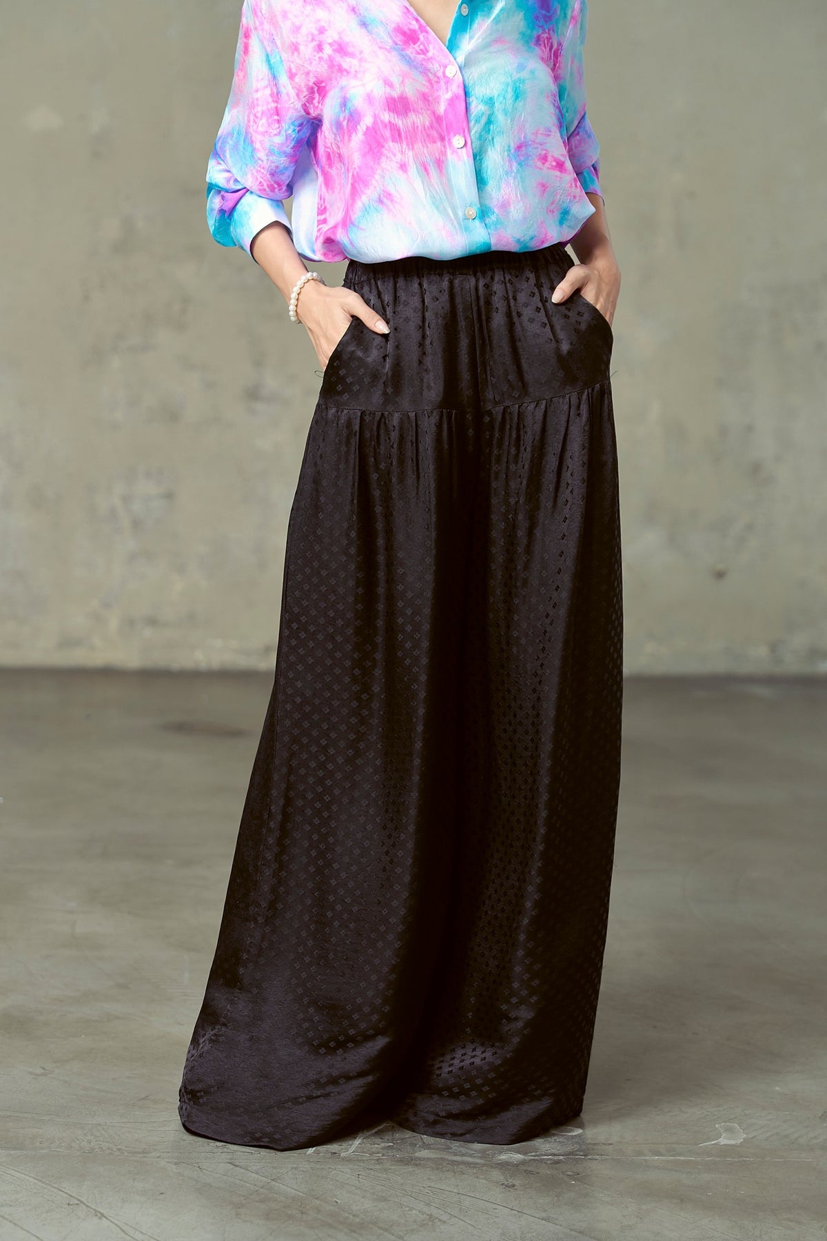 Close-up of Portia black silk trousers showing smooth hip yoke, gathers and side pockets