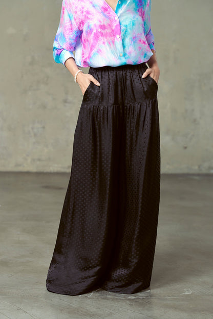 Close-up of Portia black silk trousers showing smooth hip yoke, gathers and side pockets