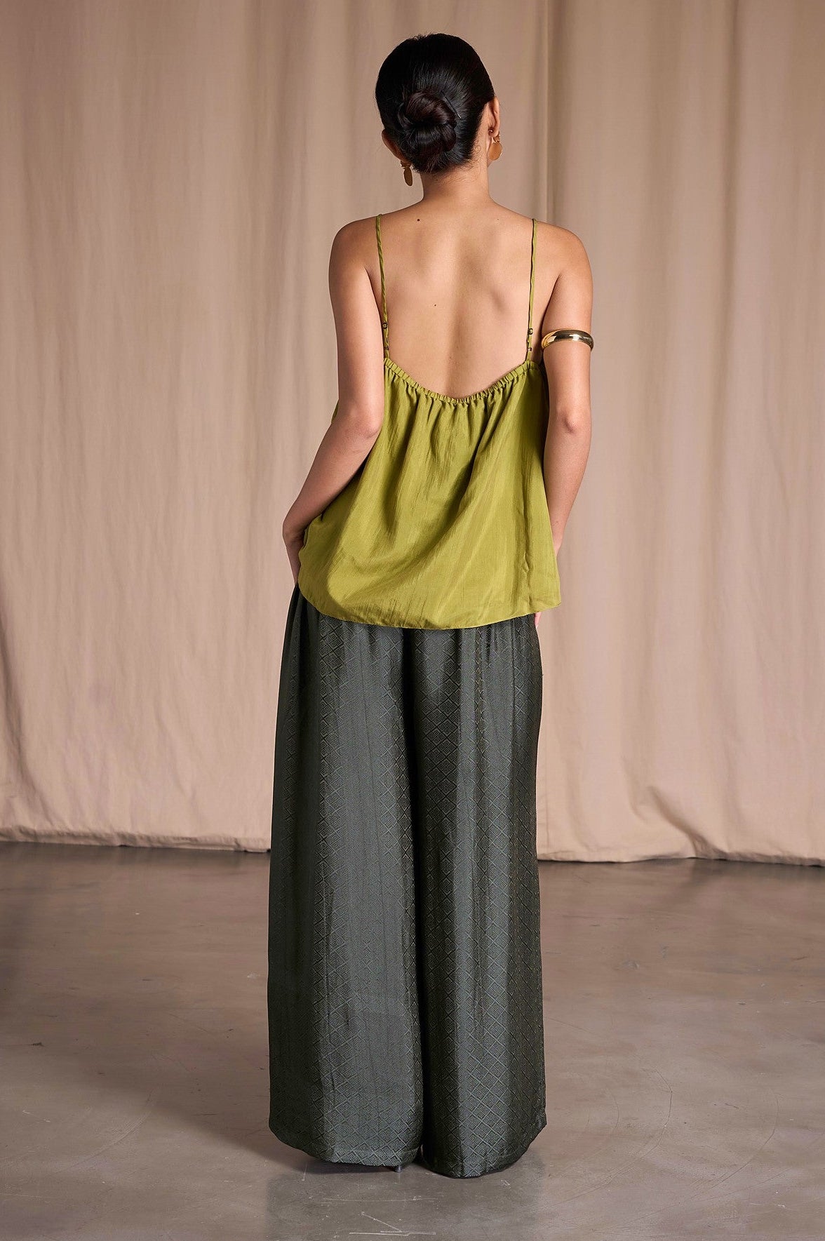 Back view of Portia Khaki Diamond silk wide-leg trousers with elasticated back waist and an olive silk camisole