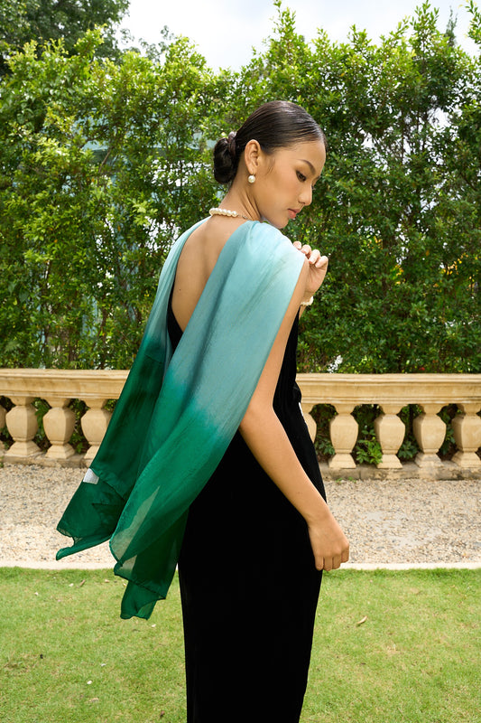 Blue and emerald ombre silk scarf draped down the back