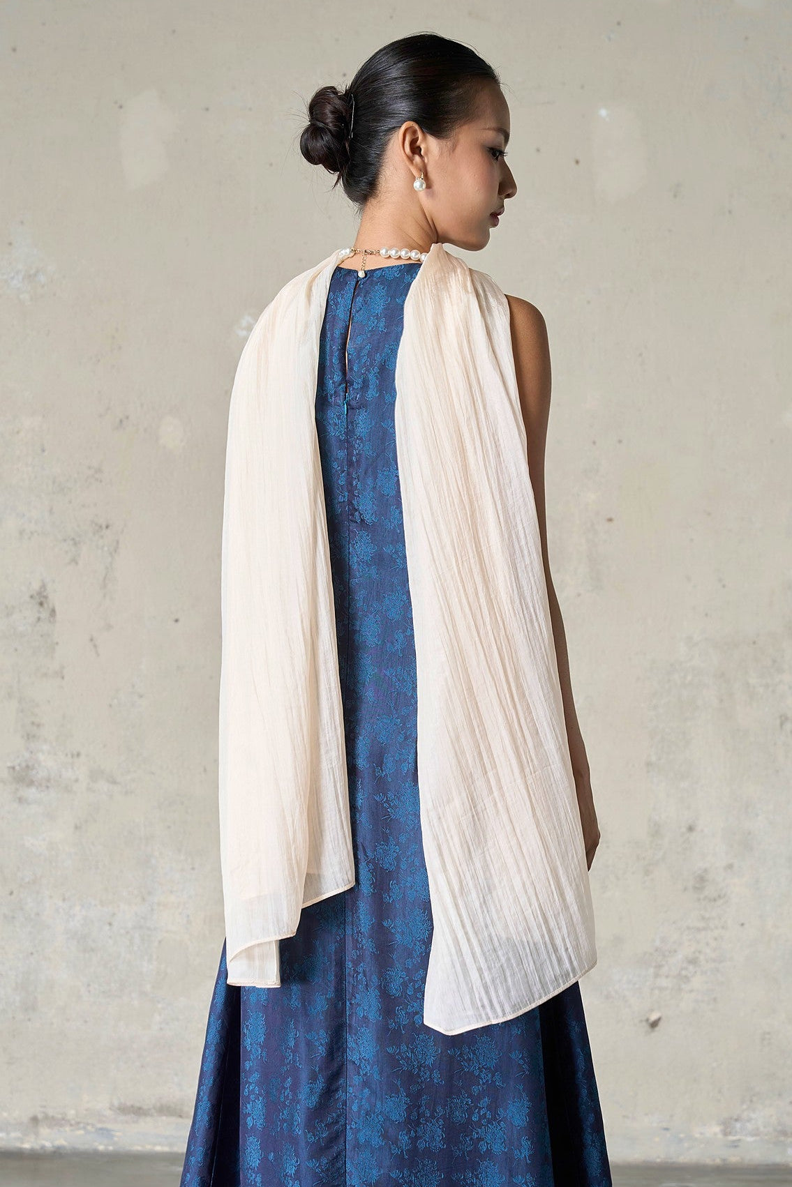 Champagne silk wrap draped straight down the back over a navy jacquard dress