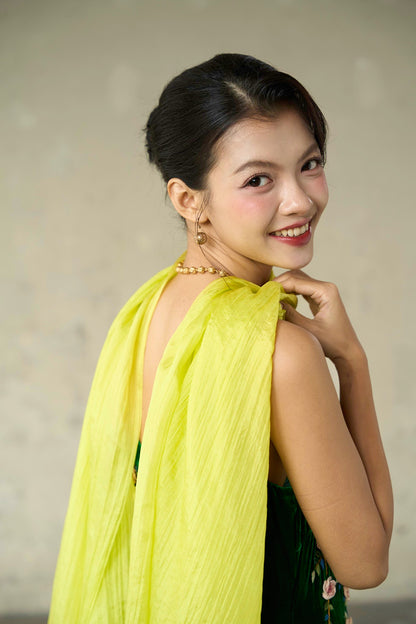 Back three-quarter view of the citrine hand-dyed silk scarf draped across the shoulders