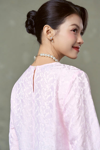 Keyhole opening and single button at the back neck of the Rosalind blush pink silk blouse
