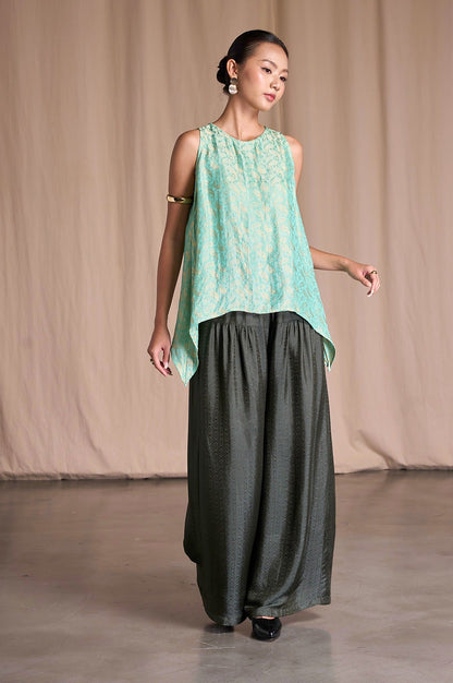 Model in Portia Khaki Diamond silk jacquard wide-leg trousers with a mint jacquard top, full length