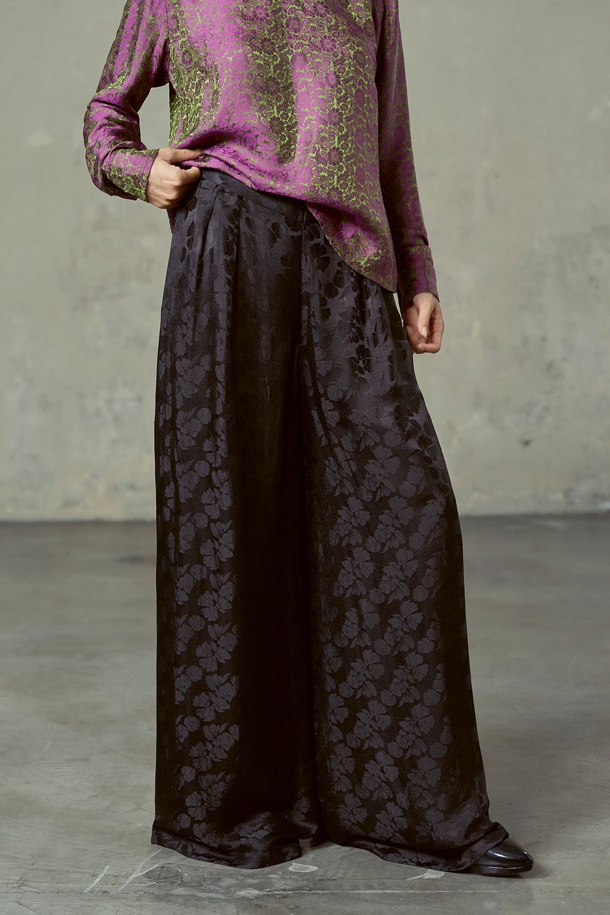 Full wide leg of black peony silk jacquard trousers falling to the floor
