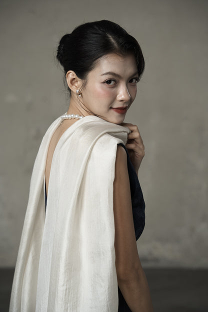 Oyster silk scarf folded over the shoulder as a wedding guest wrap