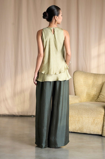 Back view of Portia Khaki Diamond silk wide-leg trousers styled with a sage tiered silk top