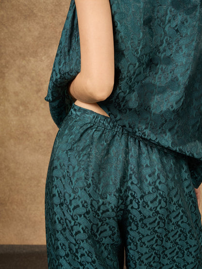 Detail of the Ophelia teal dynasty wide-leg silk palazzo trousers