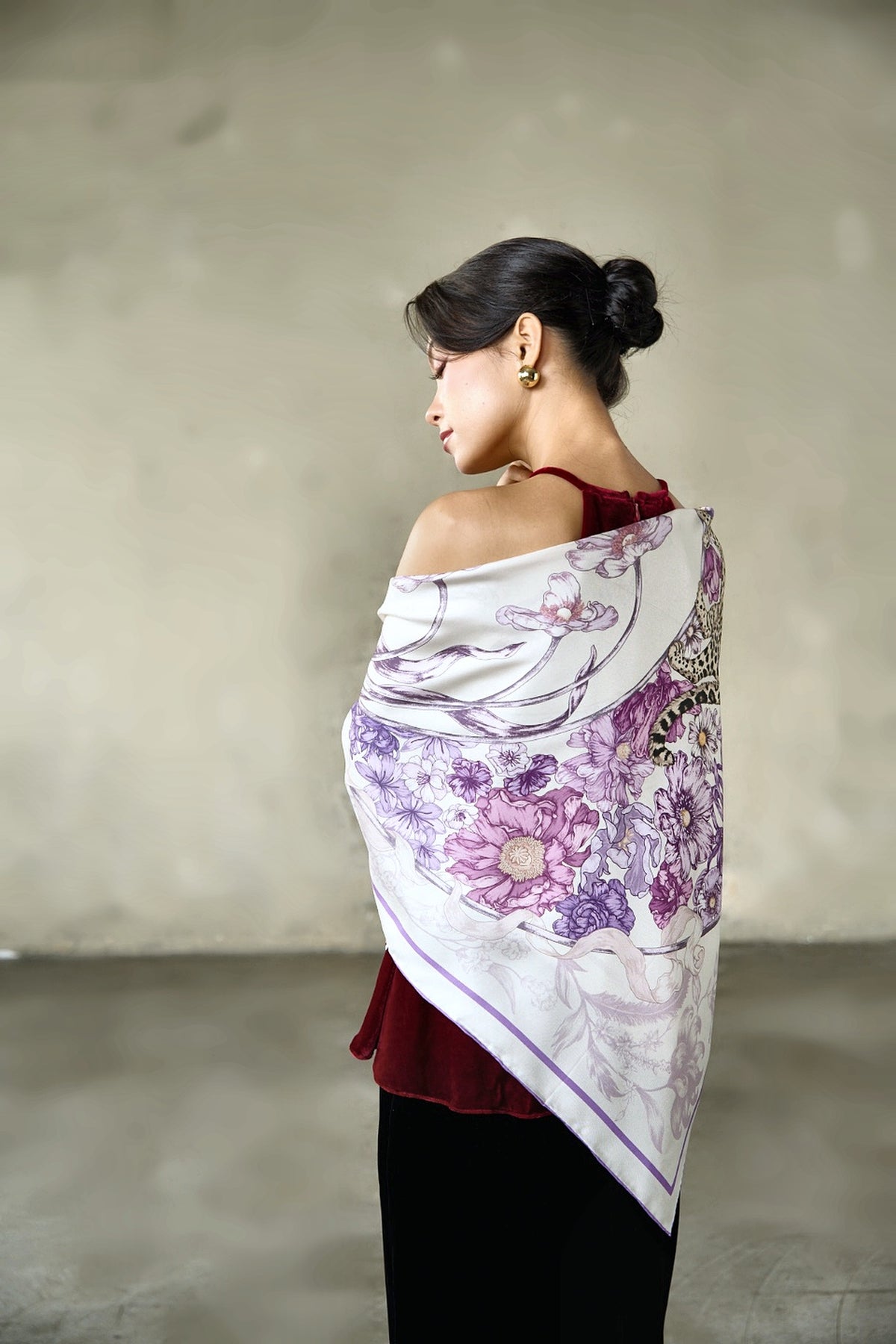 Lilac leopard and floral twill silk scarf draped across the back and shoulders, showing the full print