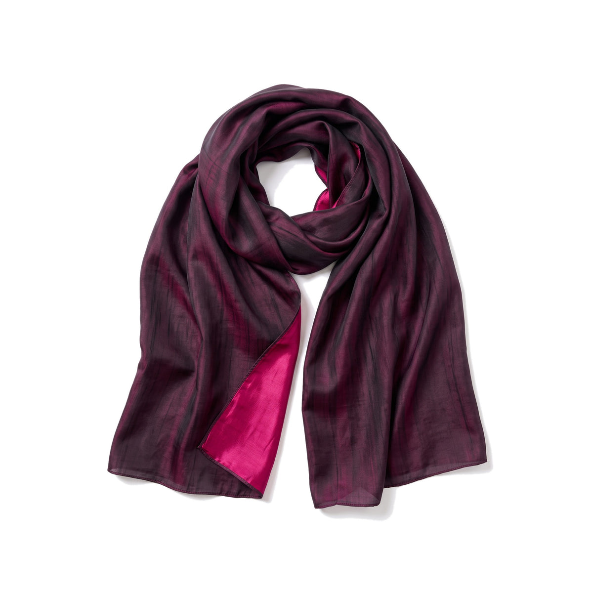 Plum and fuchsia reversible silk shawl laid flat on white, plum face outward with the fuchsia reverse turned back