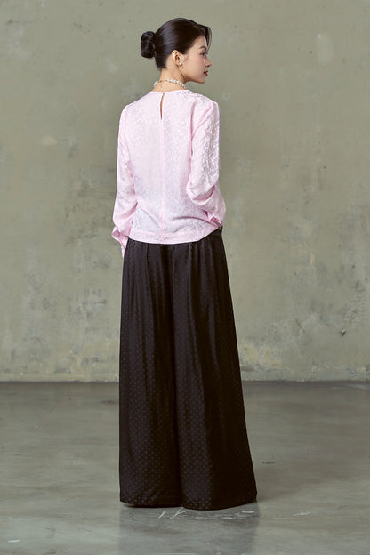 Back view of floor-length black diamond-dot silk wide-leg trousers