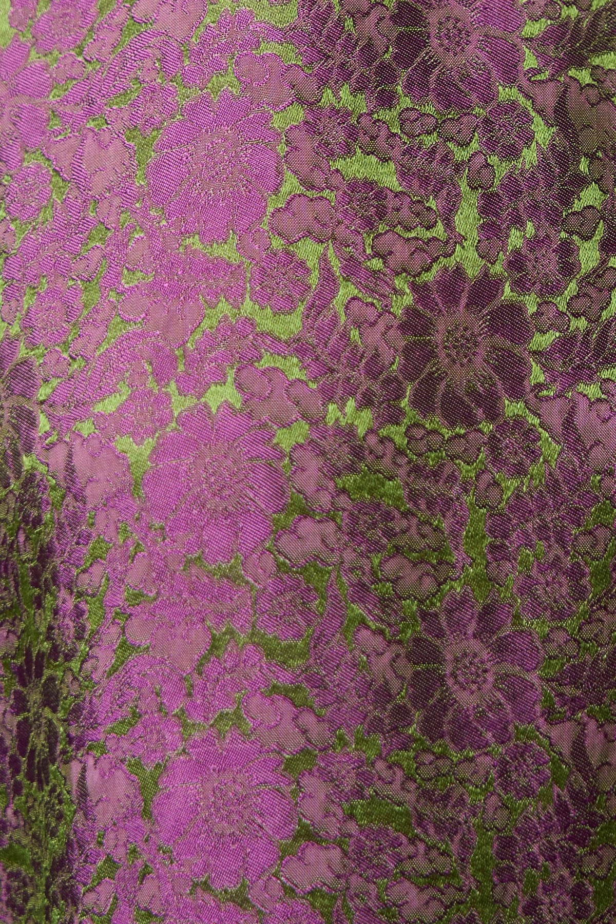 Fabric detail of magenta silk jacquard with an olive-green woven floral and leaf pattern