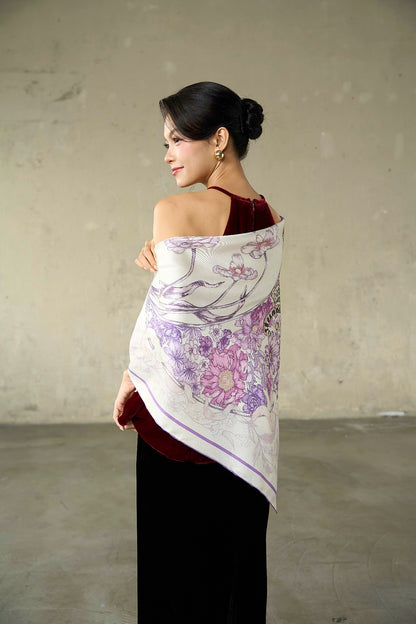 Model wearing the lilac leopard silk twill scarf as a shoulder wrap over a burgundy velvet top
