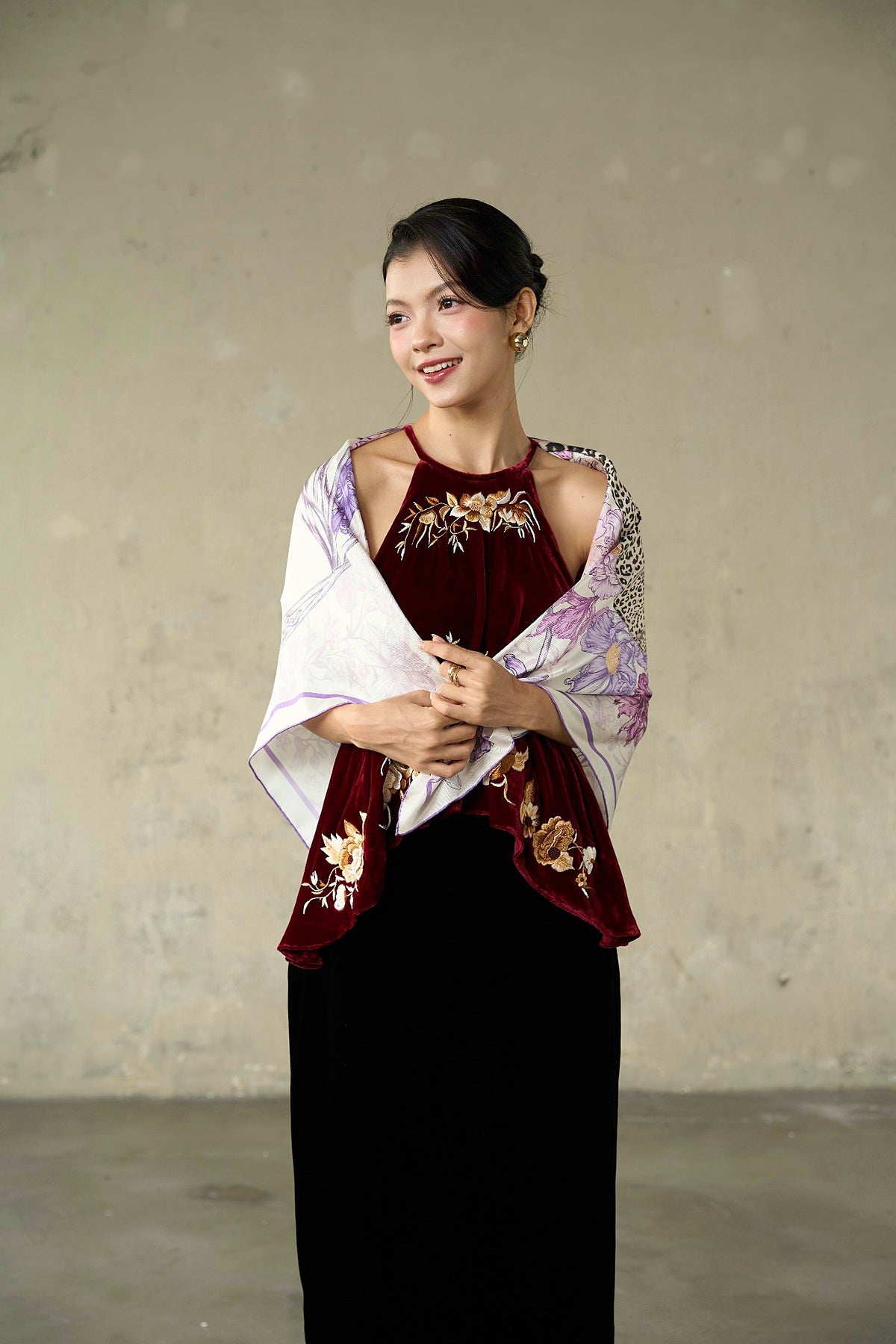 Full-length view of the lilac leopard silk twill scarf styled as a shawl with a black skirt