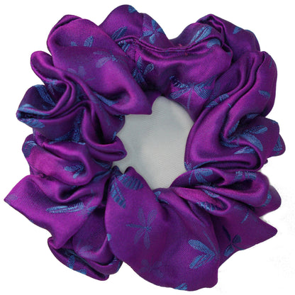 Close-up of the woven dragonfly motif on the silk jacquard scrunchie