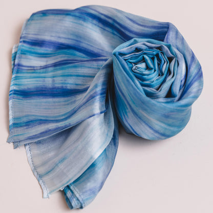Back view of a model wearing the sky blue brushstroke silk shawl