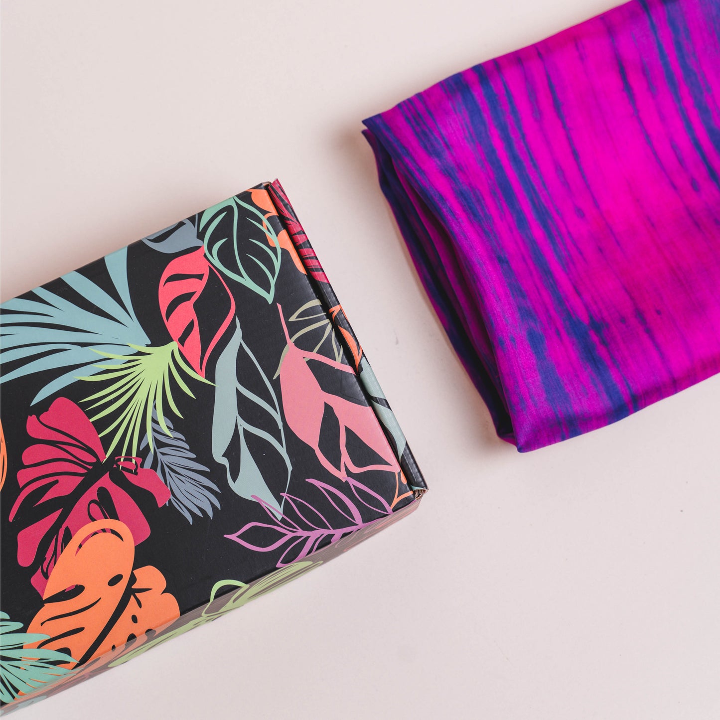 Fuchsia and blue brushstroke silk scarf held open to show the full vibrant colour