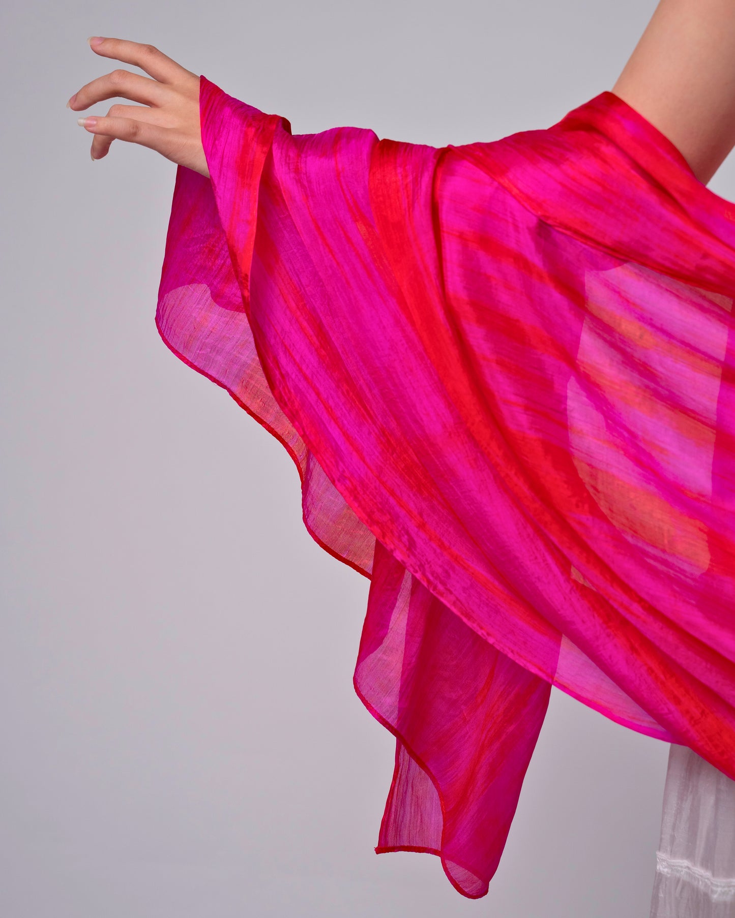 Hot pink brushstroke silk scarf held open to show the full design