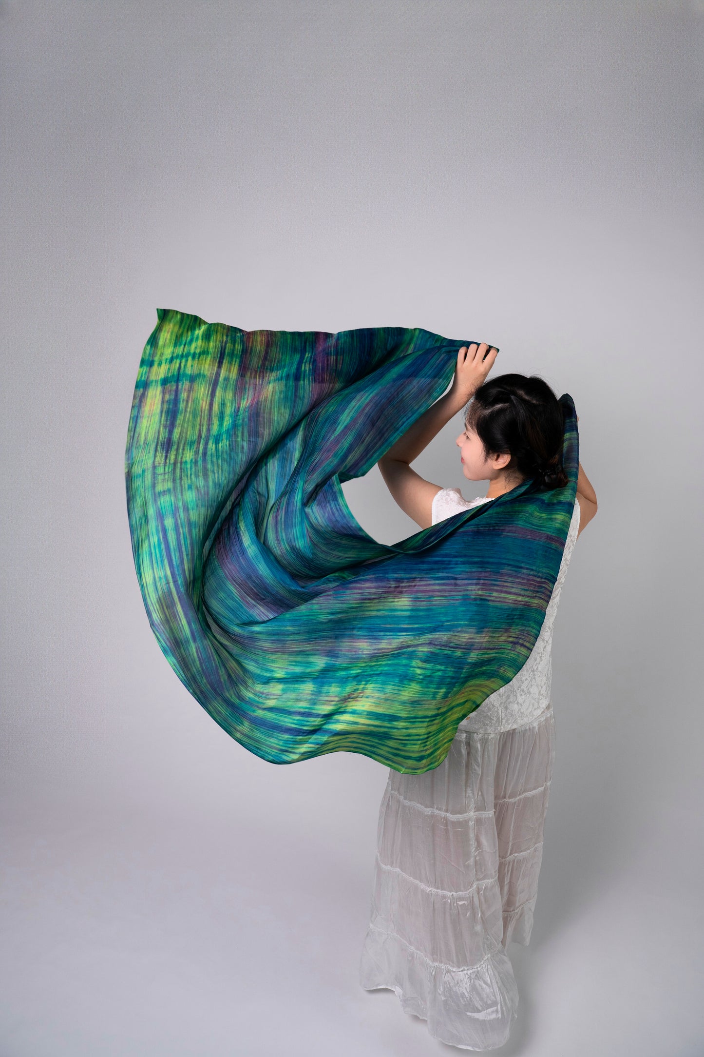 Close-up of the emerald brushstroke silk scarf, showing hand-painted texture and lustre