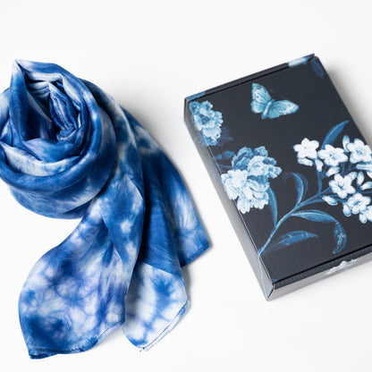 Model holding the indigo blue shibori silk shawl, showing artisan craftsmanship