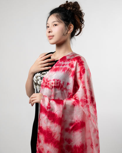 Crimson red shibori mulberry silk scarf styled loosely around the neck