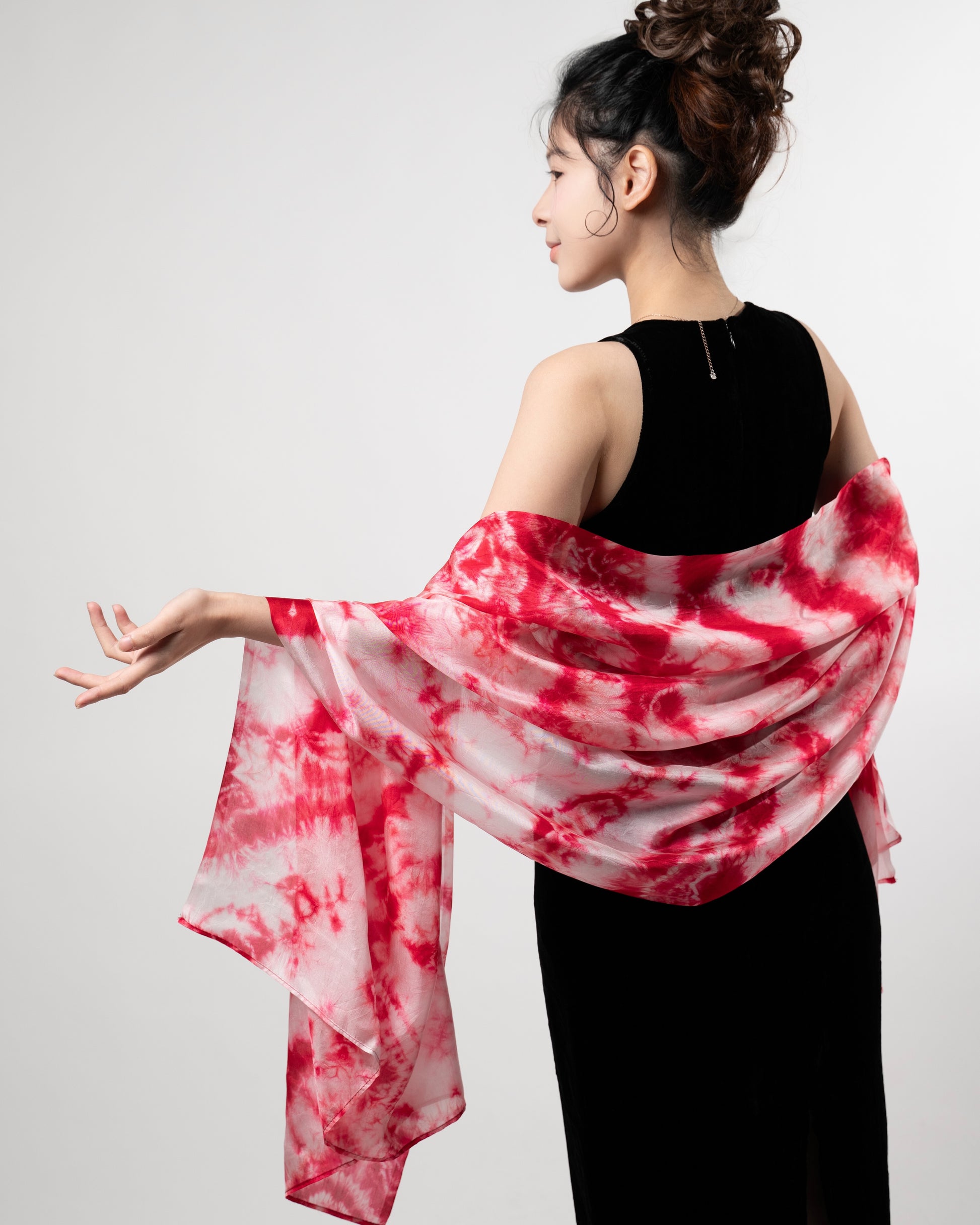 Back view of a model wearing the crimson red shibori silk shawl