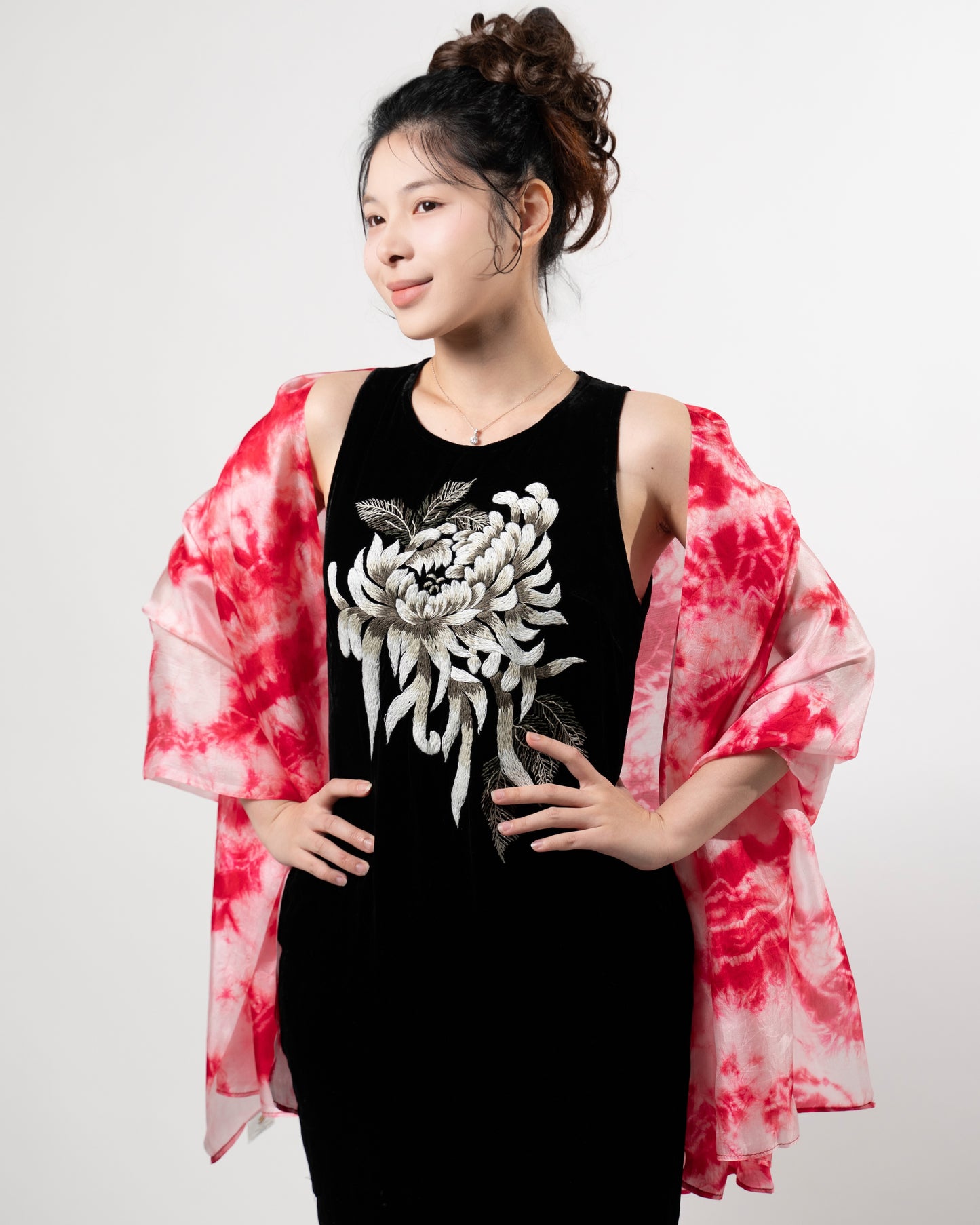 Close-up of the crimson red shibori silk scarf, showing the resist-dyed pattern