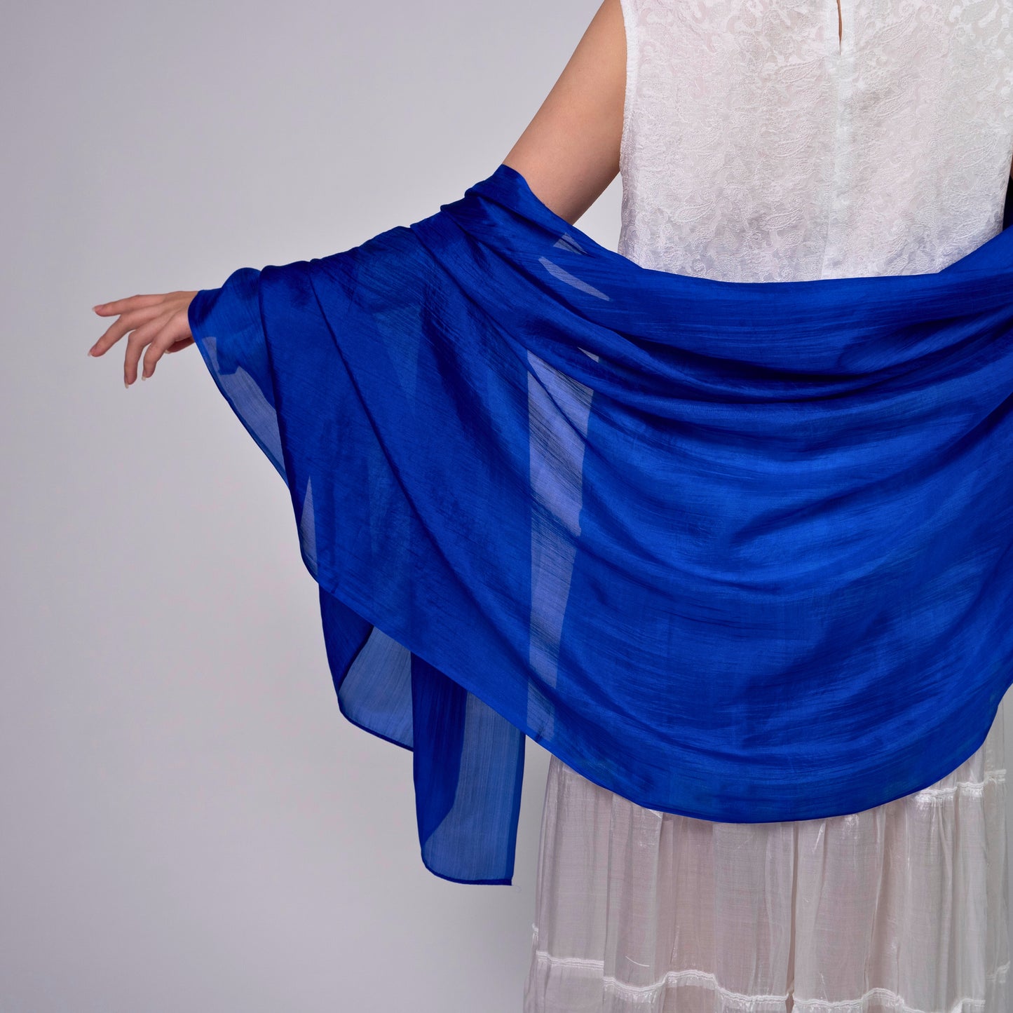 Close-up of the royal blue hand-dyed silk scarf, showing texture and lustre