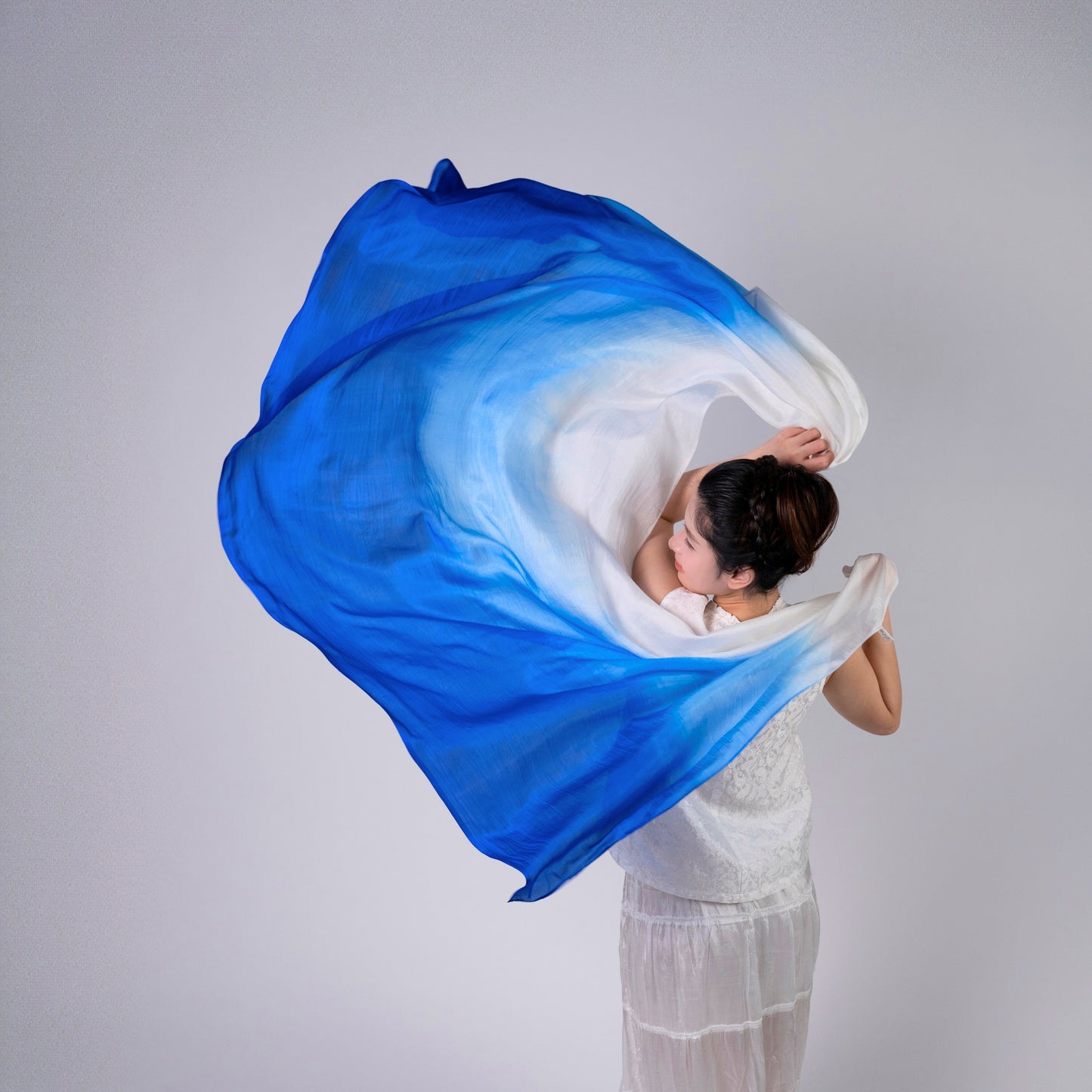 Close-up of the royal blue ombre silk scarf, showing the graduated colour